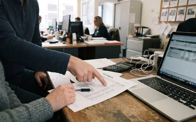 A landlord reviewing a fee breakdown document with a letting agent